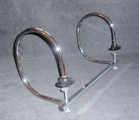 A Pair of Chrome Bicycles Stands on a Gray Surface, Reflecting Light and Showcasing Their Sleek Design.